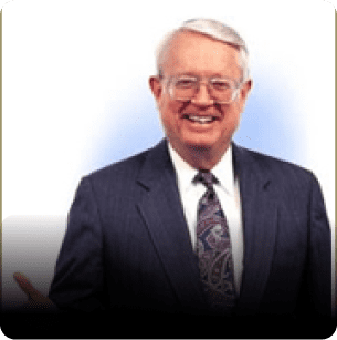 A man in suit and tie smiling for the camera.