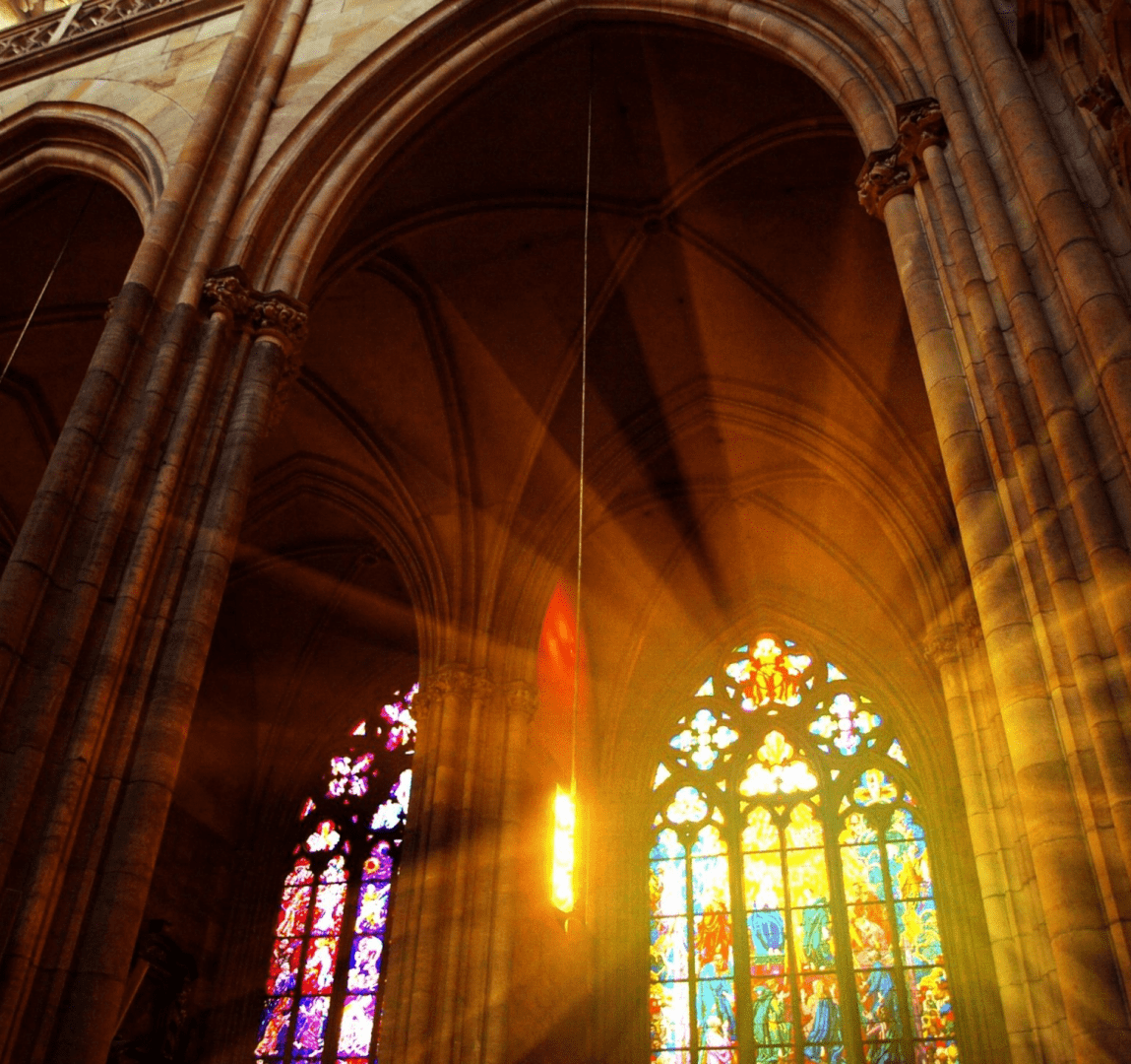 A cathedral with stained glass windows and arches.